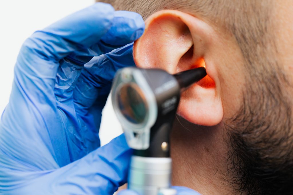 Audiologist evaluating patient for hearing loss