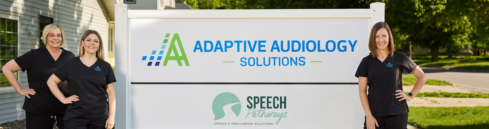 adaptive audiology team outside building